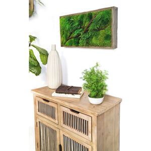 Red Branch 12” x 24” Plant Painting® in rustic grey frame on wall above wooden cabinet with decor.