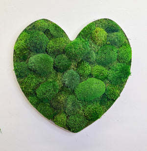 Heart-shaped lush moss art with distressed metal wine barrel frame.